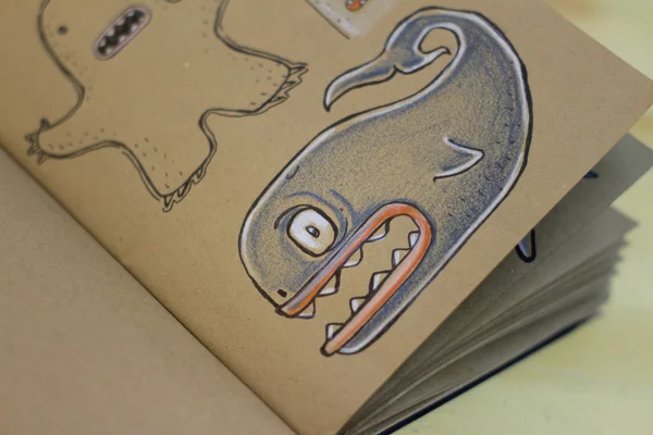 Whale cartoon drawing on a notebook