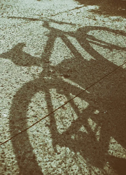 Shadow of   bicycle on asphalt — Stock Photo, Image