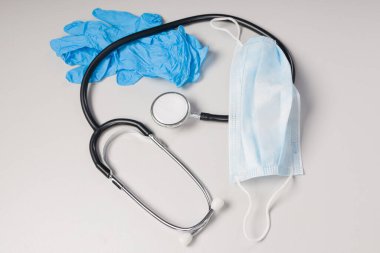 Tıbbi eldivenli doktor ekipmanı, tıbbi yüz maskesi ve steteskop.