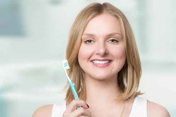 Young Smiling Blonde Woman Shows Her White Teeth Presents Her — Stock Photo, Image