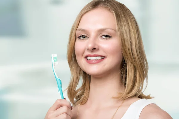 Young Smiling Blonde Woman Shows Her White Teeth Presents Her — Stock Photo, Image