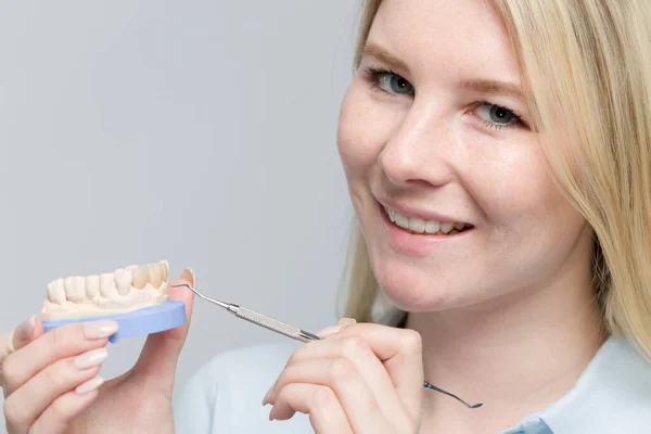 stock image Young female dental technician works on denture parts in a dental laboratory