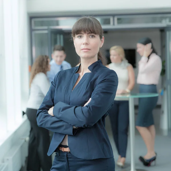 tough business woman in front of her team