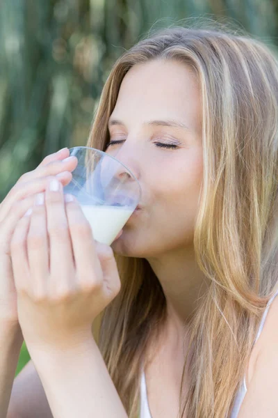 Young Blonde Woman Sitting Enjoys Glass Milk — Stock Photo, Image