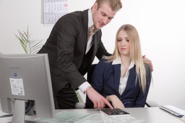 Man harassed woman at desk clipart