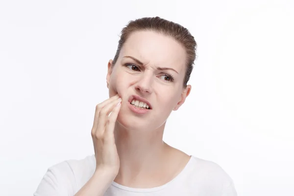 Uma jovem mulher tem uma dor de dente — Fotografia de Stock