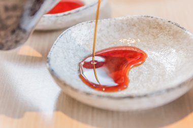 Pour the soy sauce to the bowl  clipart