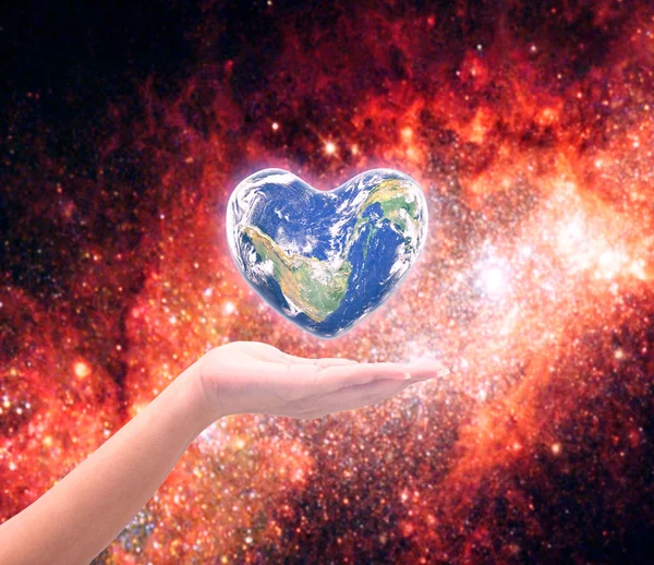 World in heart shape with over women human hands on blurred natu — Stock Photo, Image
