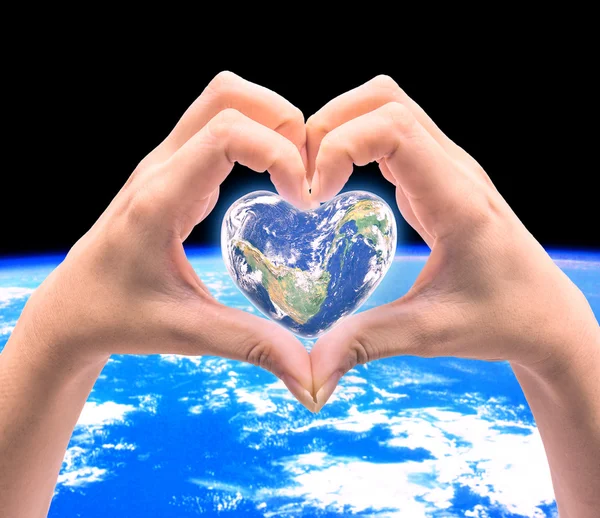 World in heart shape with over women human hands on blurred natu — Stock Photo, Image