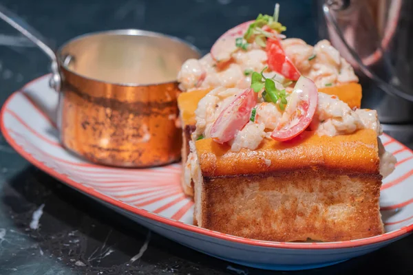 Lobster Roll.fresh Maine Lobster boiled, mixed with mayo, celery, chives served in toasted hero roll with crisp lettuce and drawn butter.