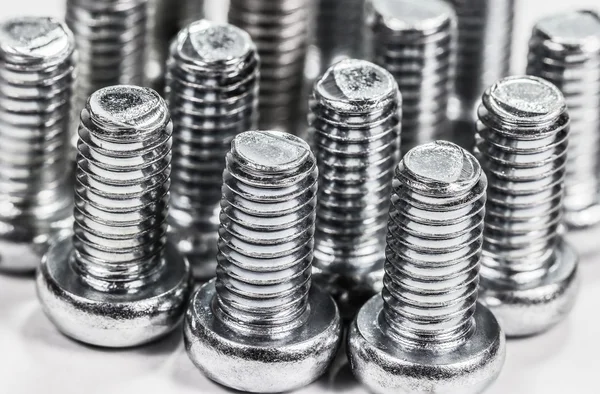 Closeup metal screw (bolt) and nuts on white background. — Stock Photo, Image