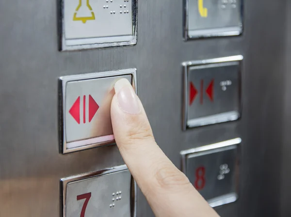 Hand press open door button in elevator — Stock Photo, Image