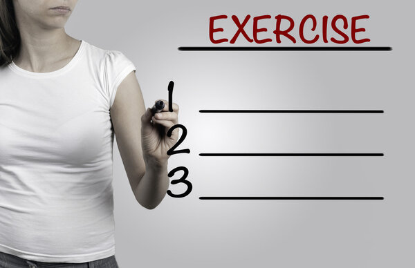 Beautiful woman writing - Exercise blank list, fitness, sport, h