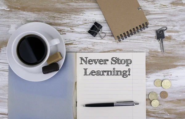 Never stop learning. Copybook on the desktop.