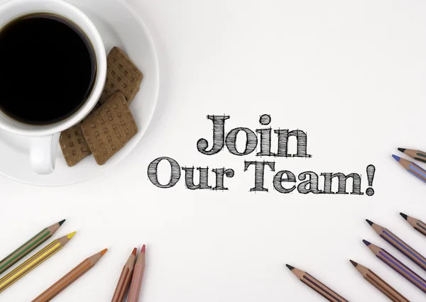 Join our team! White desk with a pencil and a cup of coffee.