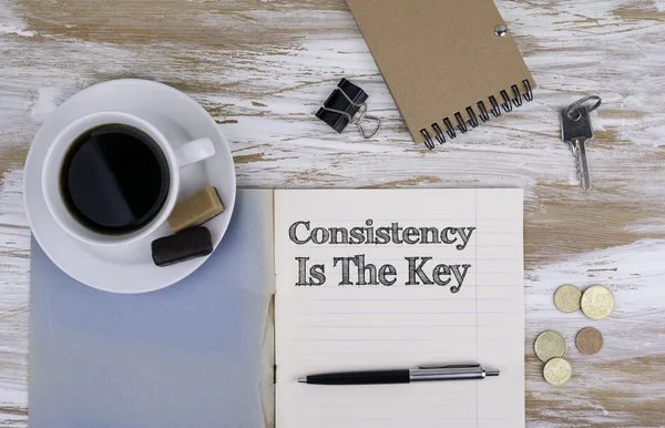 Consistency is The Key - Copybook on the desktop. — Stock Photo, Image