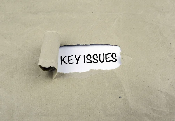 Inscription revealed on old paper - KEY ISSUES — Stock Photo, Image
