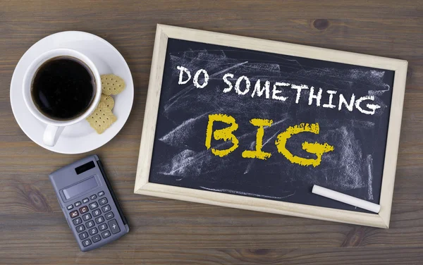 Do Something Big. Chalk board on a wooden table