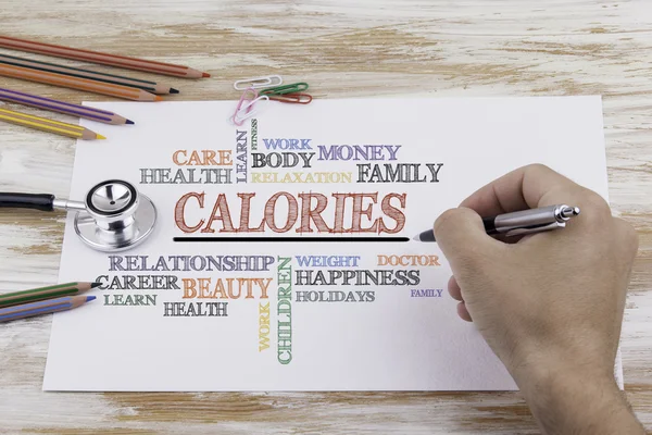 Hand met pen schrijven: calorieën — Stockfoto