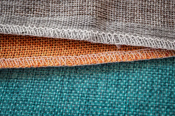 Orange, gröna och bruna textilier. Tyg för dekoration, bakgrunder och kreativa verk — Stockfoto