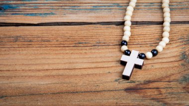 White wooden cross on an old wooden texture background. horizontal banner