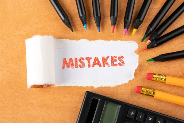 Hatalar. Yırtık kağıdın altında mesaj. Turuncu arka planda renkli kalemler — Stok fotoğraf