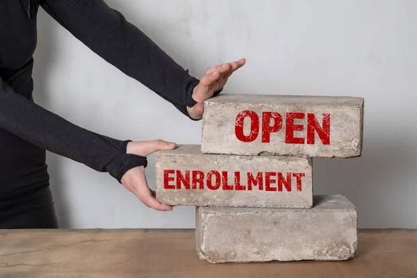 Open Enrollment concept. Stack of white bricks on a wooden table — Stock Photo, Image