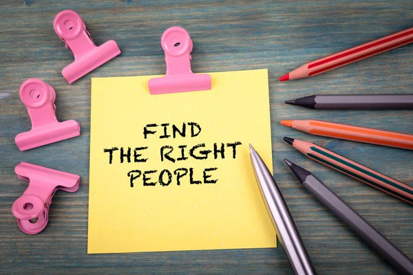 Find The Right People. Note sheet and office supplies on a green wooden background