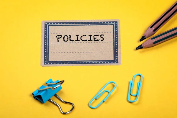 POLICIES. Yellow folder or documents with office supplies — Stock Photo, Image