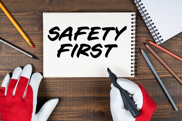 Safety First. Notebook and office supplies on wood background