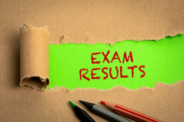 Exam Results. Torn cardboard on a green background