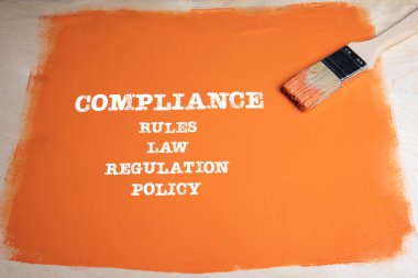 COMPLIANCE concept. Rules, Law, Regulation and Policy. Brush with an orange background clipart