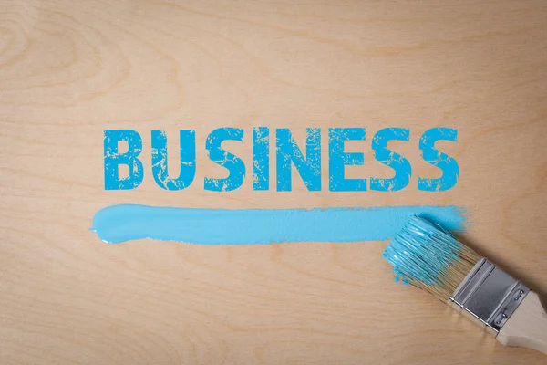 Koncepcja biznesu. Niebieski kolor z pędzlem na drewnianym tle — Zdjęcie stockowe