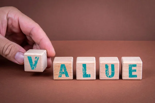 Η αξία. Ξύλινα μπλοκ με γράμματα σε καφέ φόντο — Φωτογραφία Αρχείου