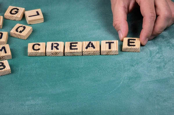 Create. Wooden blocks on a green chalk board — Stock Photo, Image