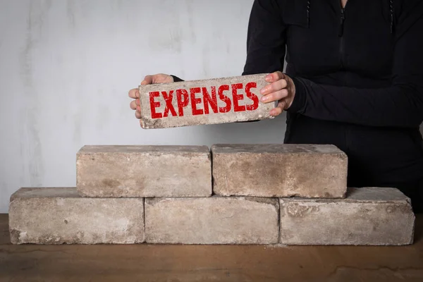 Expenses, business concept. Woman holding white brick — Stock Photo, Image