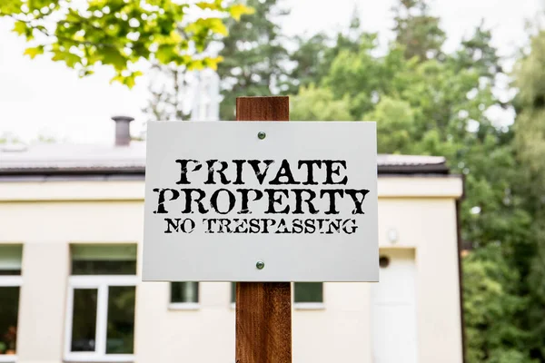 Private property no trespassing. White sign next to the property