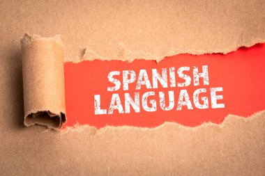 İspanyol Dili. Kırmızı arkaplanda yırtık bir karton