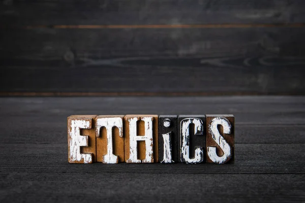 Ética. Negocios, actitudes y concepto educativo. Letras de madera blanca sobre fondo de madera oscura — Foto de Stock