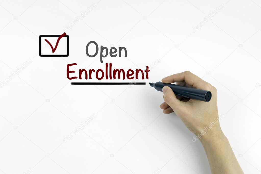 Hand with marker writing: Open Enrollment