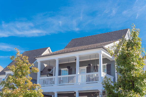 Looking up view of second story porch of typical cottage house near Dallas, Texas, America.