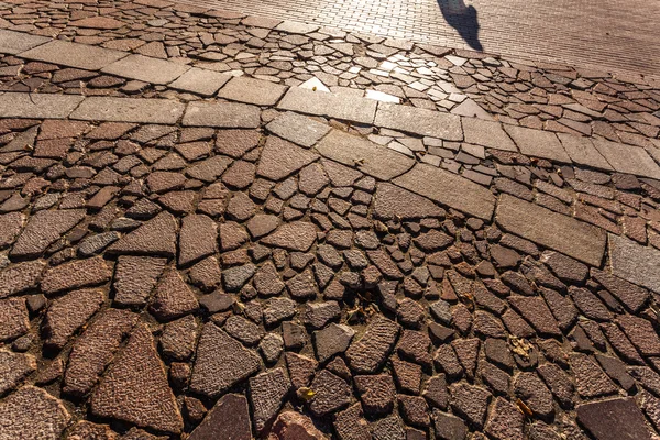 Shadow of stranger on the road — Stock Photo, Image