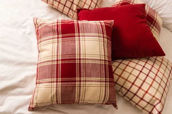 Tartan pillows on bed — Stock Photo, Image