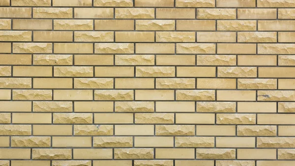 Un muro di una pietra decorativa gialla selvaggia — Foto Stock