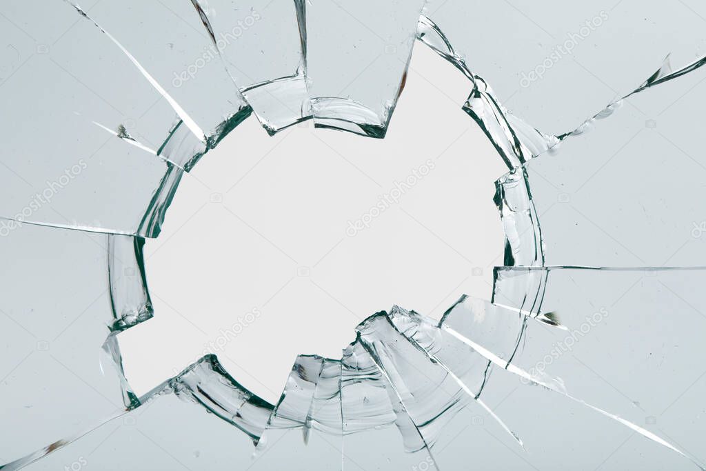 Cracks on the glass on a white background. Broken window.