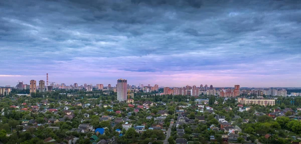 Aerial view of the suburbs and high-rise buildings at dawn.