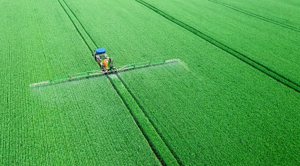 Aplicación de fertilizantes solubles en agua, pesticidas o herbicidas en el campo. Vista desde el dron. — Foto de Stock