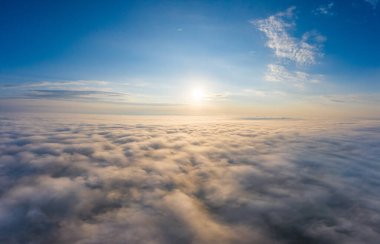 Dawn over the clouds view from the cockpit or drone.