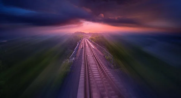 Fast movement over the railway line. Concept, rail delivery, travel and speed. Empty railway at dawn or sunset.