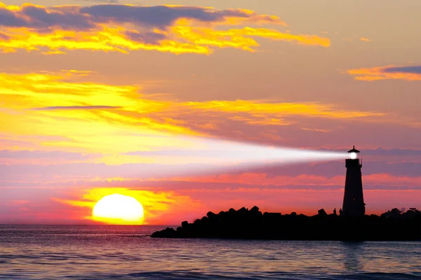 Gün batımında deniz feneri, gün batımında deniz manzarası. Sahildeki deniz feneri